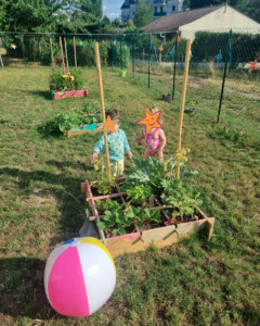 Enfants dans le jardin autour des plantations de la crèche